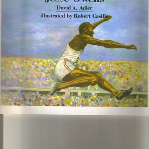 May include: A picture book titled "A Picture Book of Jesse Owens" by David A. Adler, illustrated by Robert Casilla. The cover features a colorful illustration of Jesse Owens in mid-air during a long jump, with a crowd of spectators in the background.