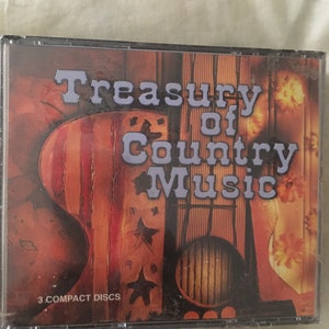 May include: A 3-disc CD set titled "Treasury of Country Music". The cover features a stylized image of a guitar with an American flag design and stars.
