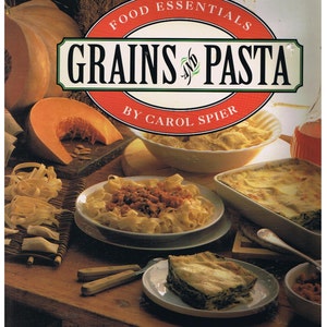 May include: A cookbook titled "Food Essentials Grains and Pasta" by Carol Spier. The cover features a variety of pasta dishes, including lasagna, spaghetti with meat sauce, and a side of pasta. The book is part of a series called "Food Essentials".