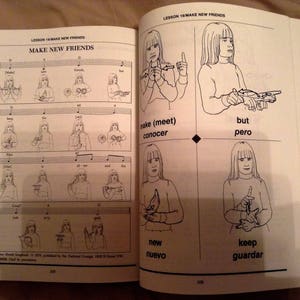 May include: A black and white illustrated book with the title "Make New Friends" and sign language illustrations for the words "make", "meet", "but", "new", "keep", "conocer", "pero", "nuevo", and "guardar".