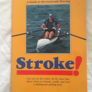 May include: A yellow book cover with the title "Stroke!" in red and blue letters. The book is about recreational rowing and features a photo of a person rowing a boat on the water. The book cover also includes the text "A Guide to Recreational Rowing" and "Bruce C. Brown".