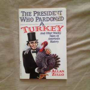 May include: A book cover with a cartoon illustration of a president pardoning a turkey. The title is "The President Who Pardoned a Turkey" and the subtitle is "And Other Wacky Tales of American History". The author is Allan Zullo.