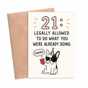 May include: A white greeting card with a brown envelope featuring the text 21: LEGALLY ALLOWED TO DO WHAT YOU WERE ALREADY DOING. Below the text is a black and white French bulldog wearing sunglasses and a party hat, holding a red cup with the word CHEERS!