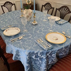 Oval vintage tablecloth with china and beautiful vase