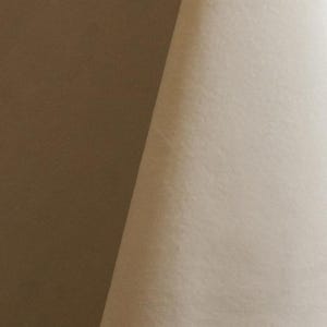 Cream upholstery velvet manufactured by Premier Table Linens. They sell the upholstery velvet by the yard.