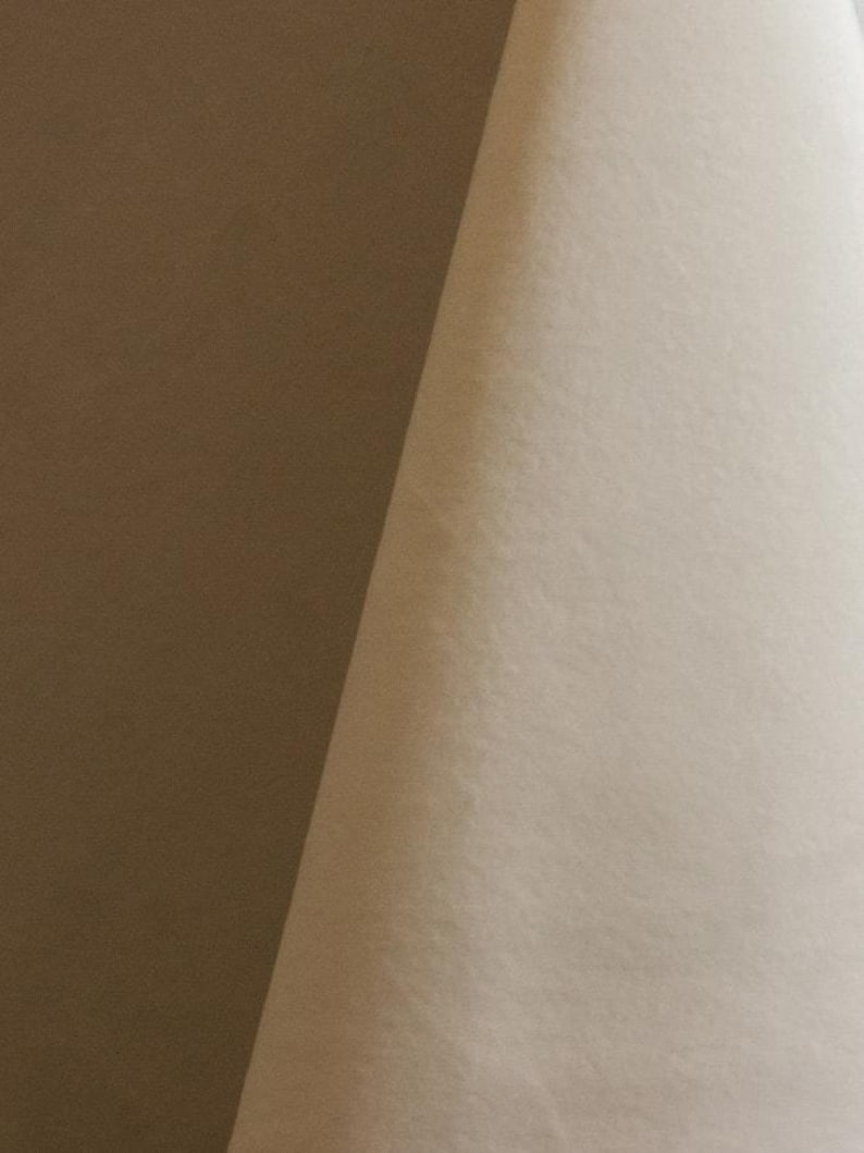Cream upholstery velvet manufactured by Premier Table Linens. They sell the upholstery velvet by the yard.