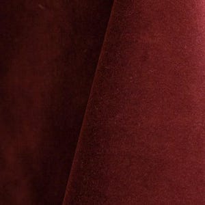 Burgundy upholstery velvet manufactured by Premier Table Linens. They sell the upholstery velvet by the yard.