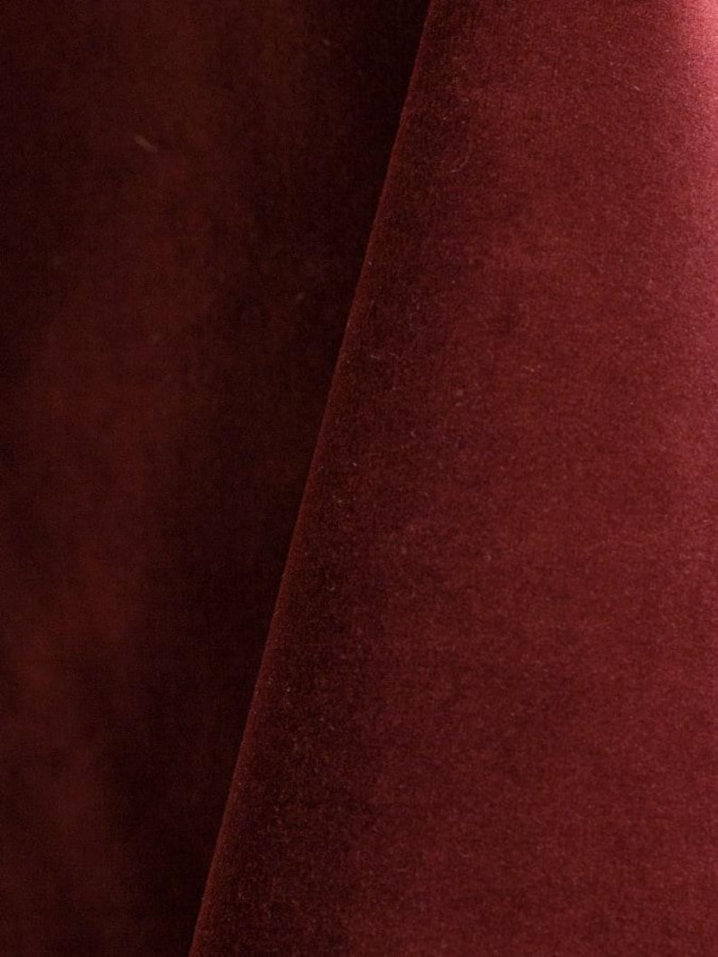 Burgundy upholstery velvet manufactured by Premier Table Linens. They sell the upholstery velvet by the yard.