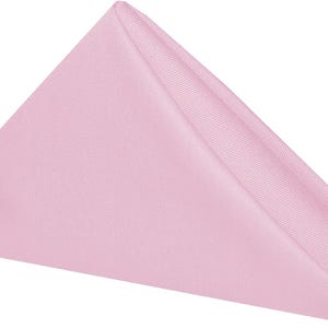 A folded pink napkin. The napkin is a cotton napkin manufactured by Premier Table Linens.