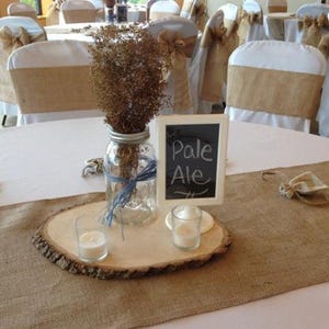 Wedding reception tables with burlap table runners at this rustic wedding.