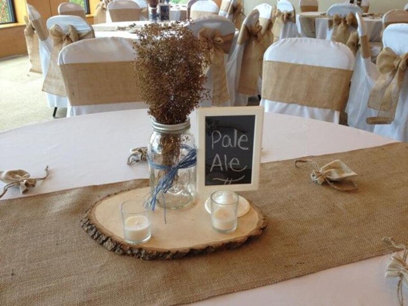Wedding reception tables with burlap table runners at this rustic wedding.