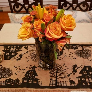 Halloween table runner with haunted house, witch and ghost.