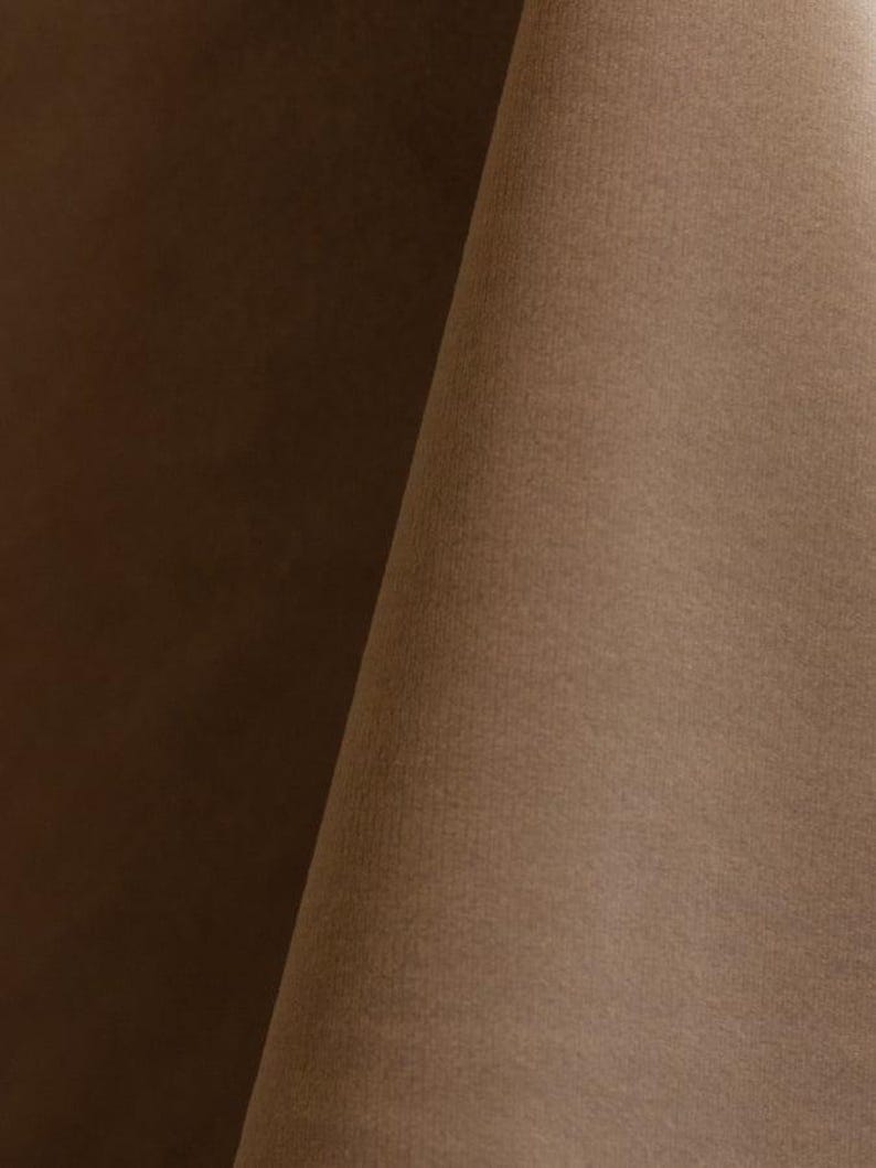 Close-up of a cashmere velvet upholstery fabric with a soft, textured surface.
It is 105,000 rub tested which is excellent durable quality manufactured by Premier Table Linens.