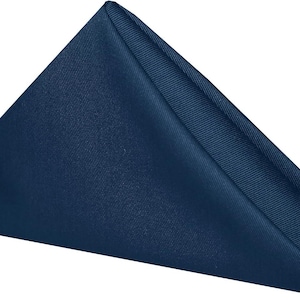 A folded blue napkin. The napkin is a cotton napkin manufactured by Premier Table Linens.
