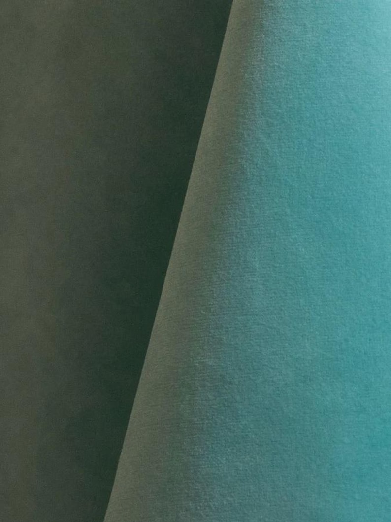 Close-up of a aqua blue velvet upholstery fabric with a soft, textured surface.
It is 105,000 rub tested which is excellent durable quality manufactured by Premier Table Linens.