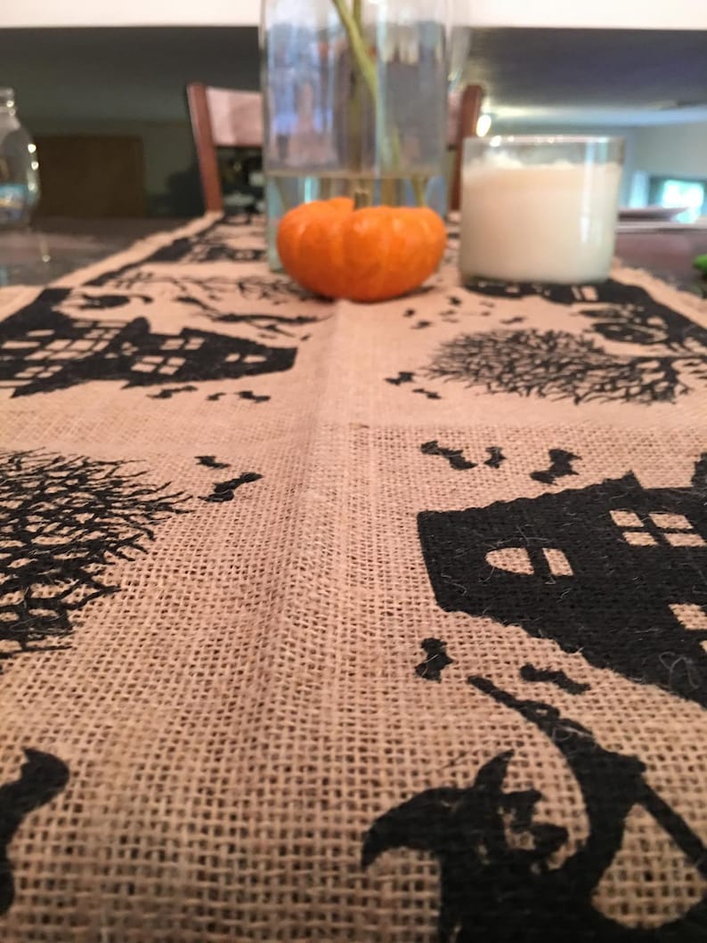 Halloween table runner with haunted house, witch and ghost.