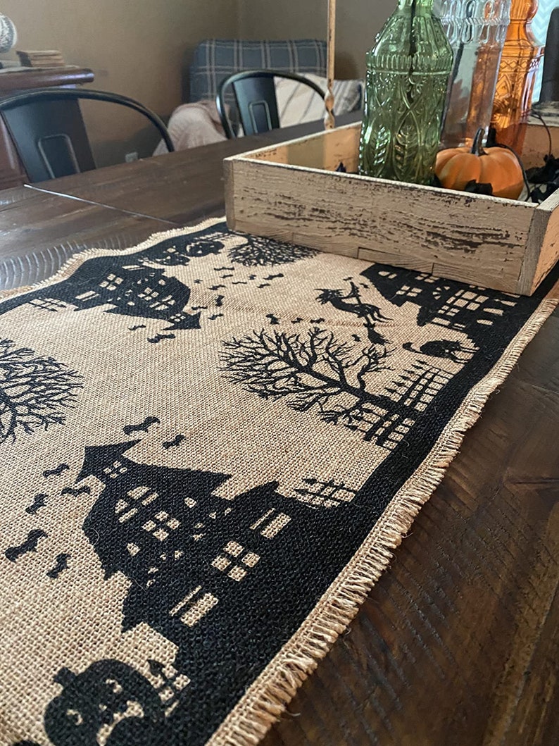 Halloween table runner with haunted house, witch and ghost.