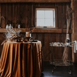 A round brown velvet tablecloth in a farmhouse.
