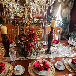Red napkins on a table set for an elegant meal.