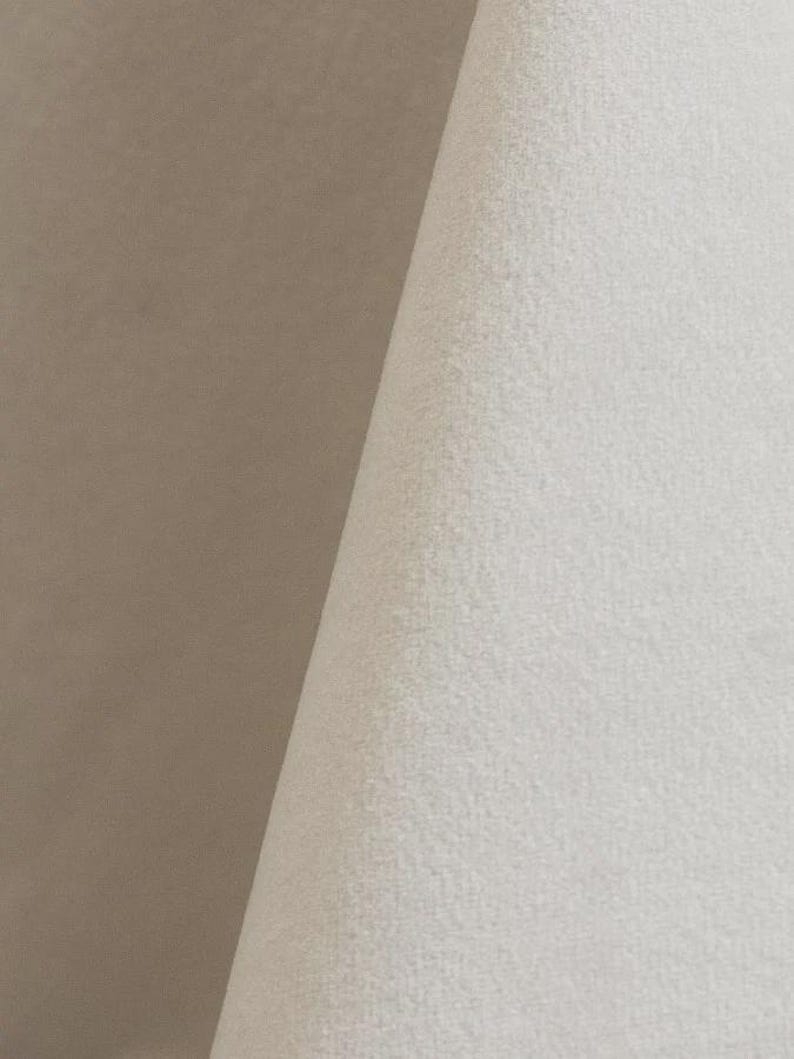 Close-up of a white velvet upholstery fabric with a soft, textured surface.
It is 105,000 rub tested which is excellent durable quality manufactured by Premier Table Linens.