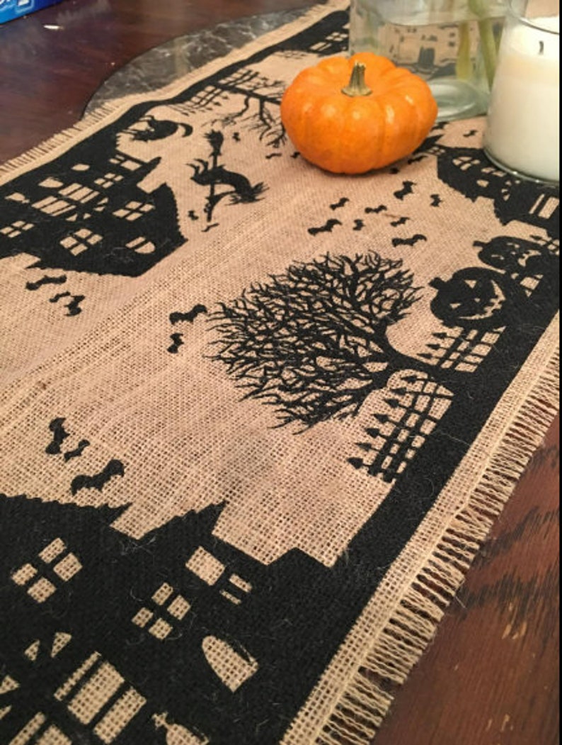 Halloween table runner with haunted house, witch and ghost.