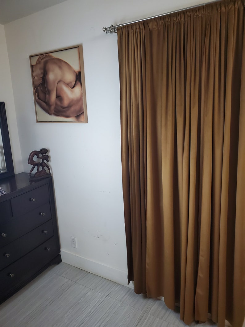 Gold velvet curtains in a bedroom. Beautiful velvet drapes