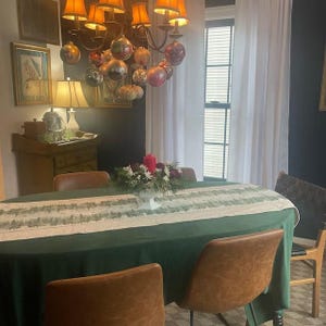 A green velvet tablecloth and table runner during the holidays.