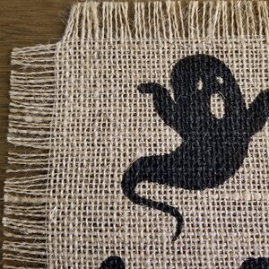 Halloween table runner with haunted house, witch and ghost.