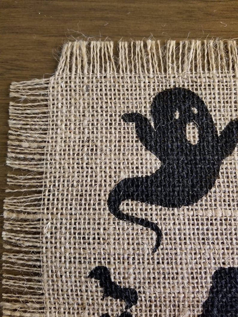 Halloween table runner with haunted house, witch and ghost.