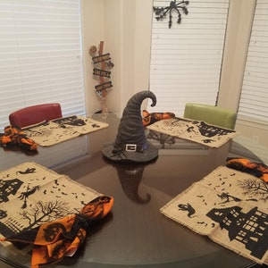 Halloween placemats with haunted house, witch and ghost.