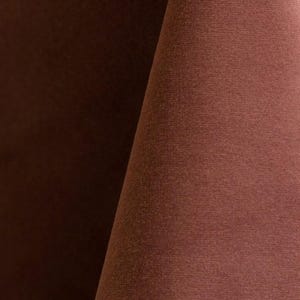 Close-up of a cashmere velvet upholstery fabric with a soft, textured surface.
It is 105,000 rub tested which is excellent durable quality manufactured by Premier Table Linens.