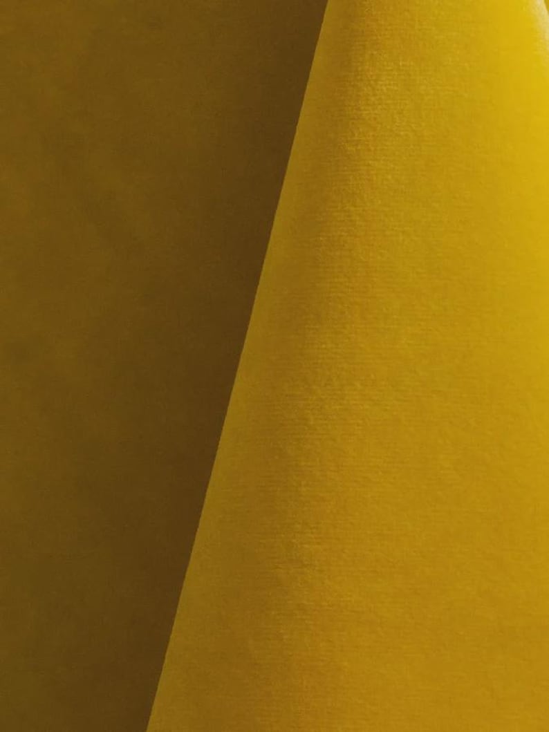 Close-up of a sunshine velvet upholstery fabric with a soft, textured surface.
It is 105,000 rub tested which is excellent durable quality manufactured by Premier Table Linens.