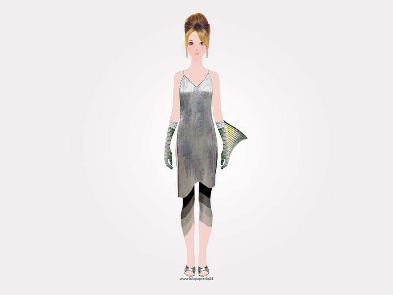 May include: A woman wearing a silver sequined dress with a fishtail design. She is wearing black and green leggings and green gloves.