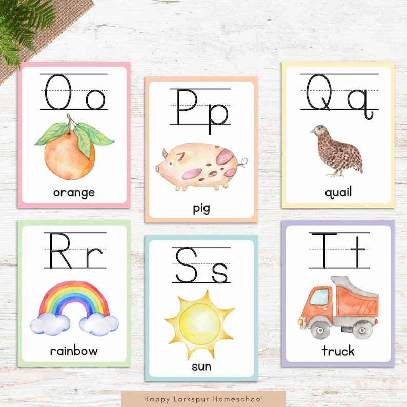 May include: Six colorful flashcards with uppercase and lowercase letters, a picture, and a word for each letter. The letters are O, P, Q, R, S, and T. The pictures are an orange, a pig, a quail, a rainbow, a sun, and a truck.