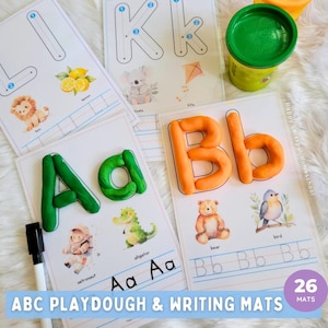 May include: A set of 26 alphabet playdough and writing mats. Each mat features a different letter of the alphabet, a corresponding picture, and lines for tracing the letter. The mats are printed on white paper with colorful illustrations. The text "Happy Larkspur Homeschool" and "ABC Playdough & Writing Mats" are printed on the mats. The number 26 is printed in a purple circle with the word "MATS" below it.