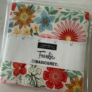 May include: A stack of square fabric swatches in a clear plastic bag, featuring a floral pattern with red, yellow, blue, and green flowers on a cream background. A white paper band with a ruler shows a width of 5 to 8 inches, labeled Moda Fabrics Supplies, Frankie, and BasicGrey.