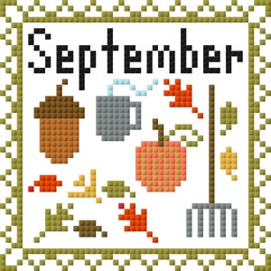 May include: A cross-stitch design featuring the word "September" in black text, surrounded by autumnal imagery including a brown acorn, a gray mug with steam, a red leaf, an orange pumpkin, a brown twig, a green leaf, and a gray rake.