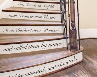 May include: A wooden staircase with white risers featuring black vinyl lettering. The text reads: And he whistled, and shouted, and called them by name: Now, Dasher! now, Dancer! now Prancer and Vixen! On, Comet! on, Cupid! on, Donner and Blitzen!