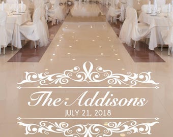 May include: A white vinyl floor decal featuring an ornate scrollwork border with the text The Addisons and the date JULY 21, 2018 in a white script and sans-serif font, designed for application on a smooth, reflective event venue floor.