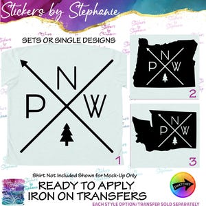 May include: A light-colored t-shirt featuring a black graphic of two crossed arrows with the letters P, N, and W, and a small pine tree. Two additional black silhouette decals of the states of Oregon and Washington are also displayed.