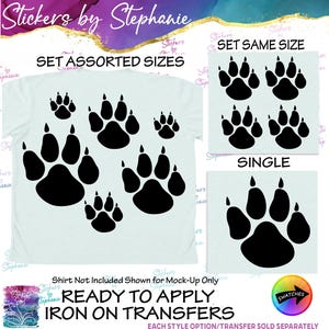 May include: A collection of black animal paw print iron-on transfers displayed on a light blue shirt mock-up, with additional panels showing a set of same-sized prints and a single large print. Text includes Stickers by Stephanie, SET ASSORTED SIZES, SET SAME SIZE, SINGLE, and READY TO APPLY IRON ON TRANSFERS.