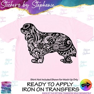 May include: A light pink t-shirt featuring a large black graphic of a dog silhouette filled with intricate floral and geometric patterns. The text Stickers by Stephanie appears at the top, and the bottom text reads Ready to Apply Iron on Transfers.