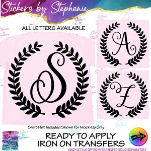 May include: A light pink iron-on transfer featuring a black letter S inside a circular laurel wreath design. The image includes text reading Stickers by Stephanie, ALL LETTERS AVAILABLE, and READY TO APPLY IRON ON TRANSFERS.