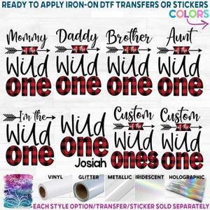 May include: A collection of iron-on DTF transfers and stickers featuring the text Mommy, Daddy, Brother, Aunt, I'm the, and Custom of the Wild One in black script and bold fonts. The word one features a red and black buffalo plaid pattern.