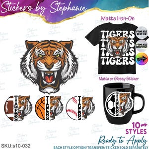 May include: A collection of tiger-themed designs featuring a snarling tiger head, the word TIGERS, and sports balls including a football, basketball, and baseball. The graphics are displayed on a black t-shirt and a black mug with text.