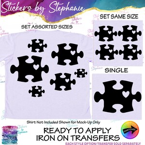 May include: A light purple t-shirt featuring black puzzle piece iron-on transfers with heart cutouts. The image displays three options: a set of assorted sizes, a set of same-sized pieces, and a single piece. Text includes Stickers by Stephanie.
