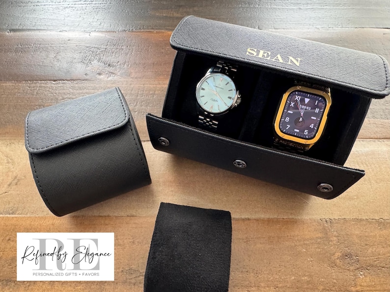 May include: Black leather watch roll with two watch slots. The roll is personalized with the name "SEAN".