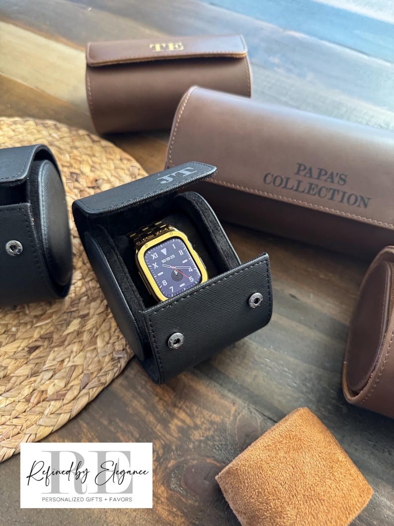 May include: Four different watch cases, two brown and two black. The black cases have a watch inside. The brown cases have the text "T.H." and "PAPA'S COLLECTION" embossed on them.