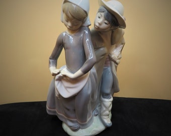 Lladro hand made in Spain Figurine Boy Trying to Kiss Girl