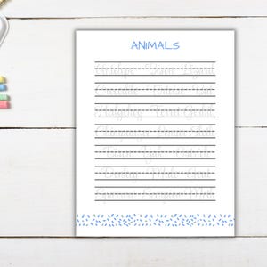 May include: A white educational worksheet titled ANIMALS in blue text, featuring rows of light grey cursive words for tracing. The page includes horizontal lines and a blue dashed pattern at the bottom border, designed for handwriting practice.